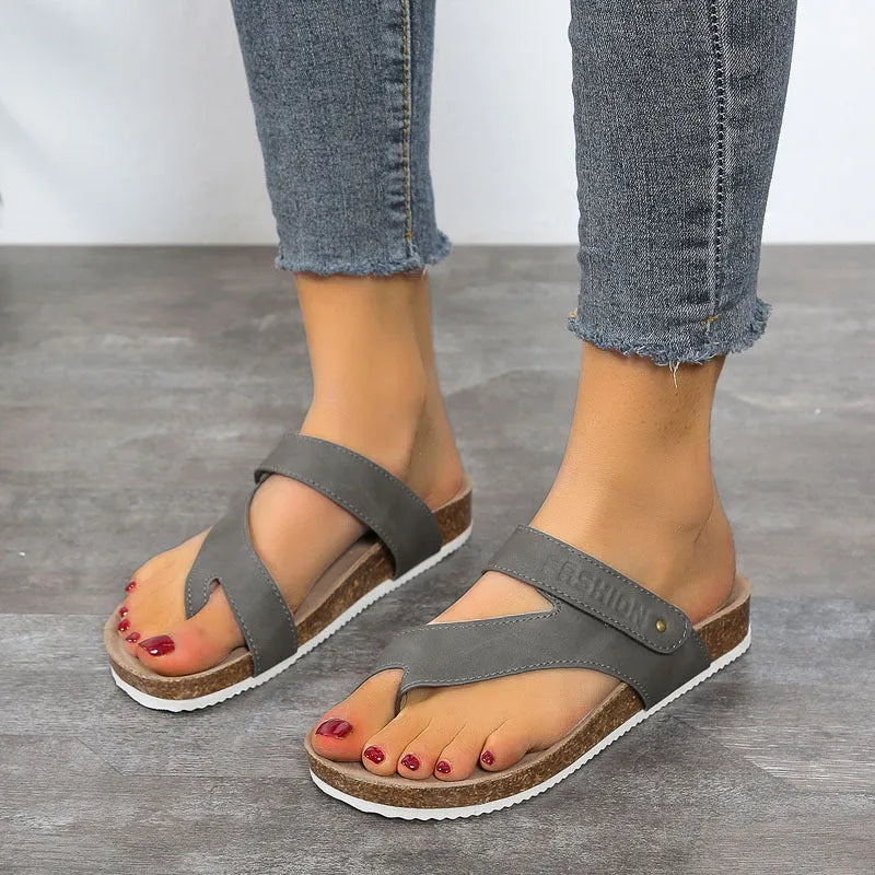 Flat toe ring thick-soled flip-flops in a solid colour on a light background