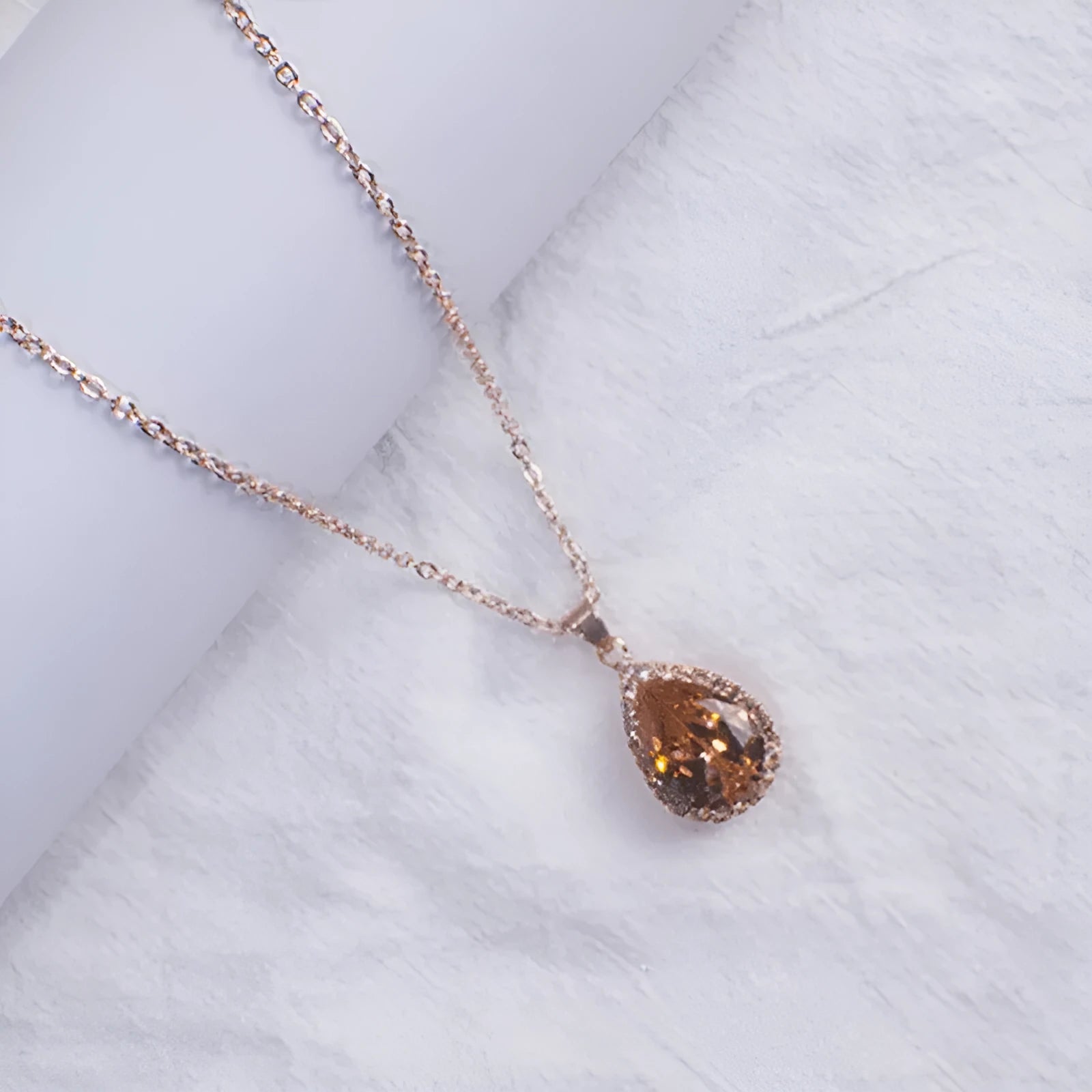 Rose gold plated drop pendant necklace with colourful rhinestones in a pink colour option.