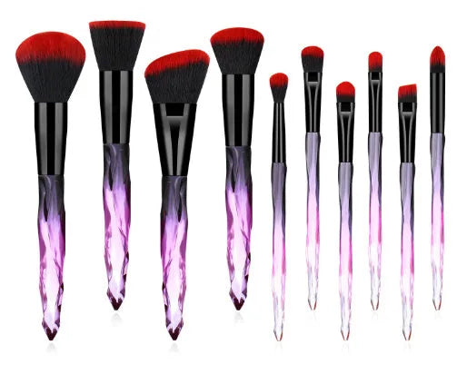 Ten crystal-handled foundation brushes with artificial fibre bristles in black, blue, red, and yellow.