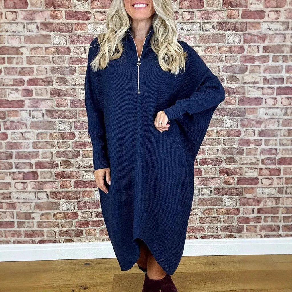Women's solid colour loose fit knit dress with raglan sleeves on a hanger.