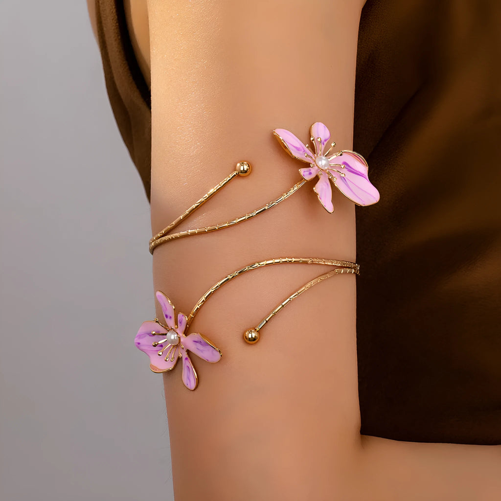 Pink alloy armband bracelet with hollow geometric linear pattern.