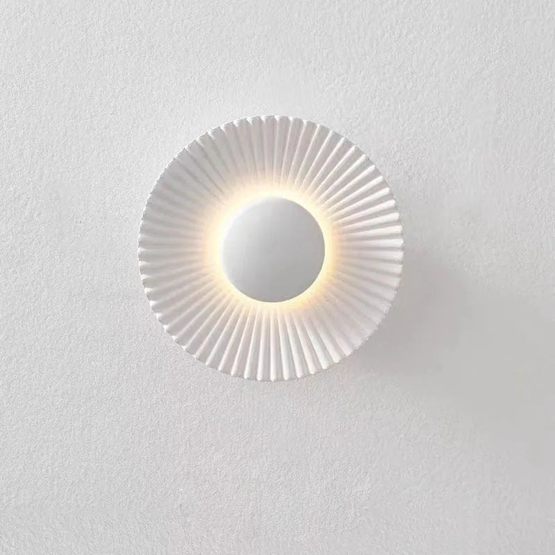 Round aluminium wall lamp with LED light in a choice of colour finishes including white and gold.
