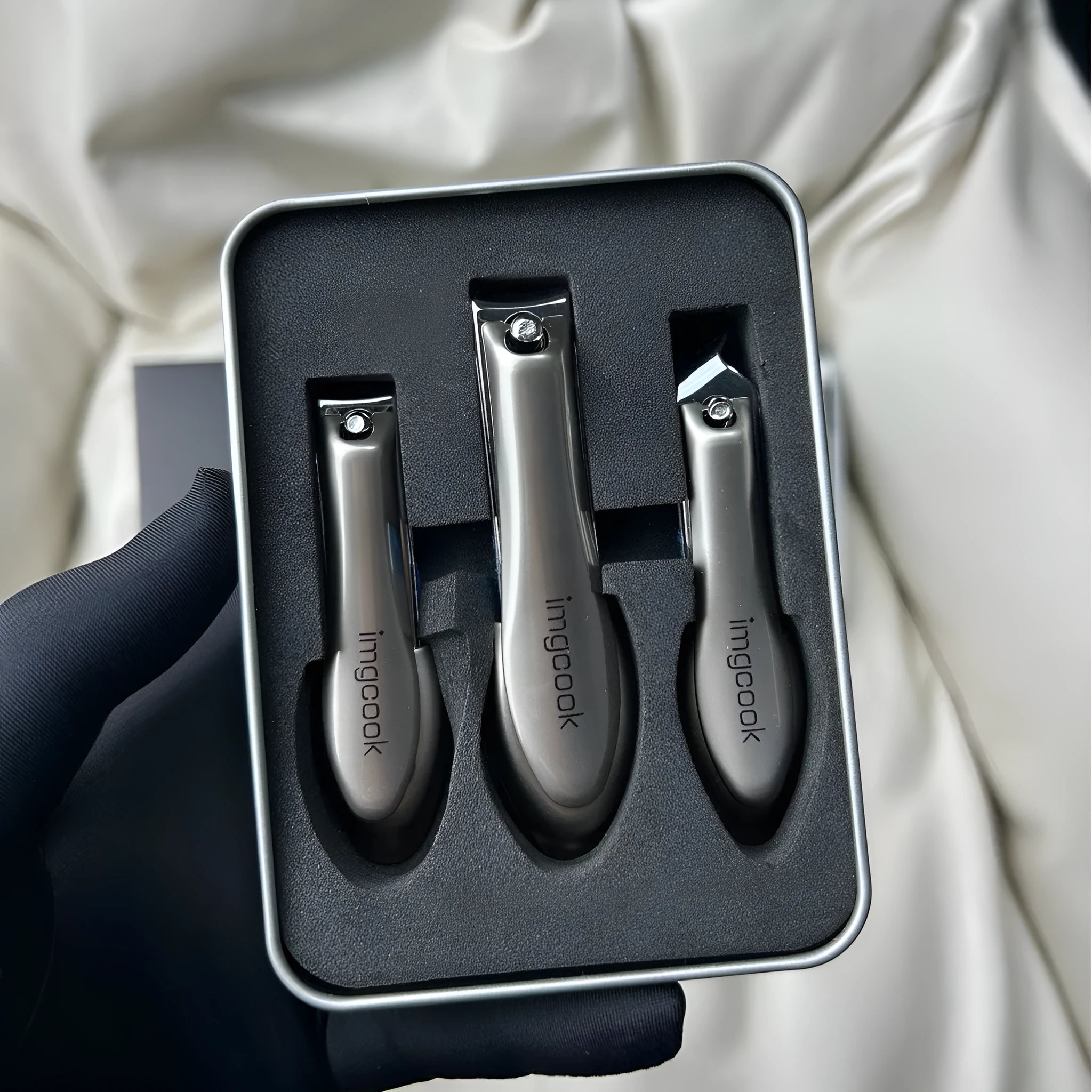 Three-piece anti-splash nail clippers set in black colour made from alloy and stainless steel
