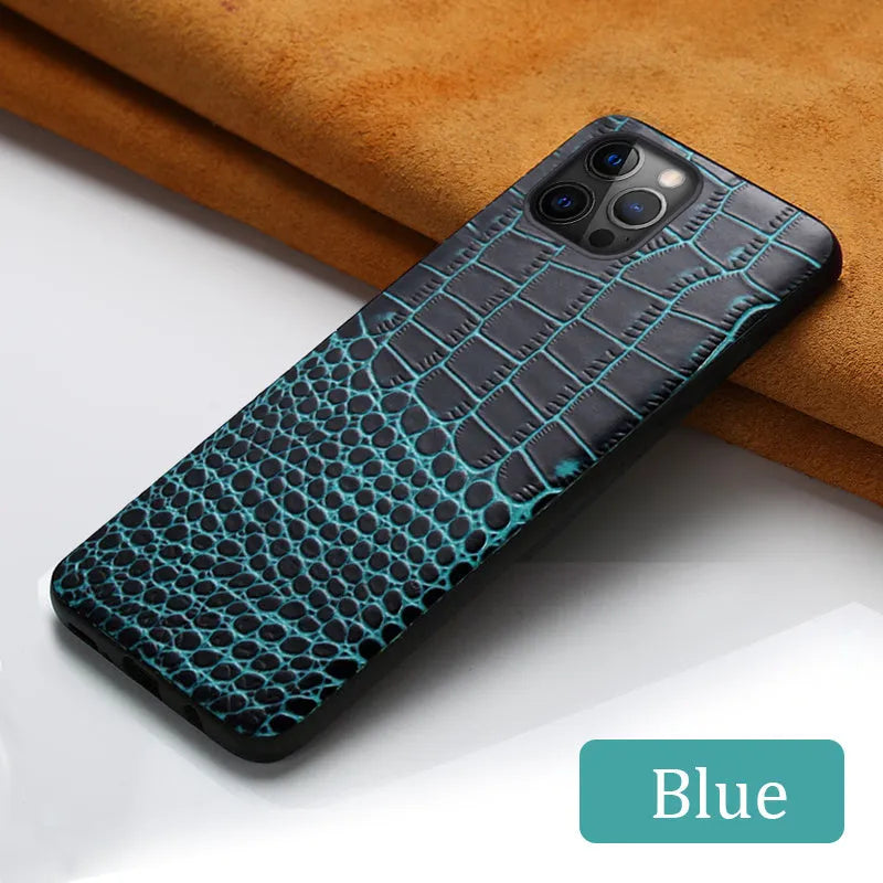 Black leather iPhone case with a crocodile pattern texture lying flat.
