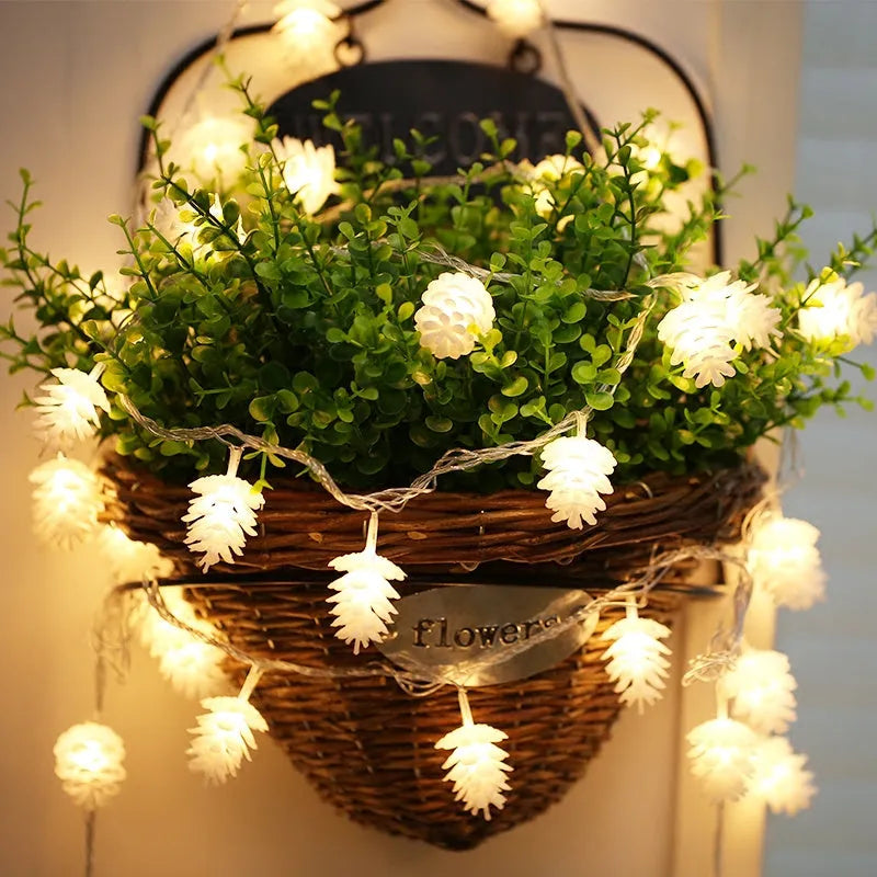 Battery-powered warm white LED pine cone light string for decorative indoor and outdoor use