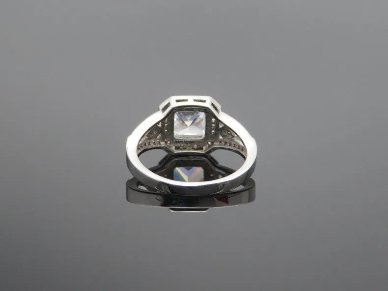 Geometric platinum colour zircon ring with quadrilateral design and hollow ornament construction