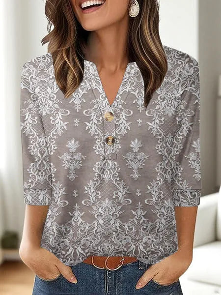 Woman wearing a loose V-neck T-shirt with a bold 3D pattern print in casual style.