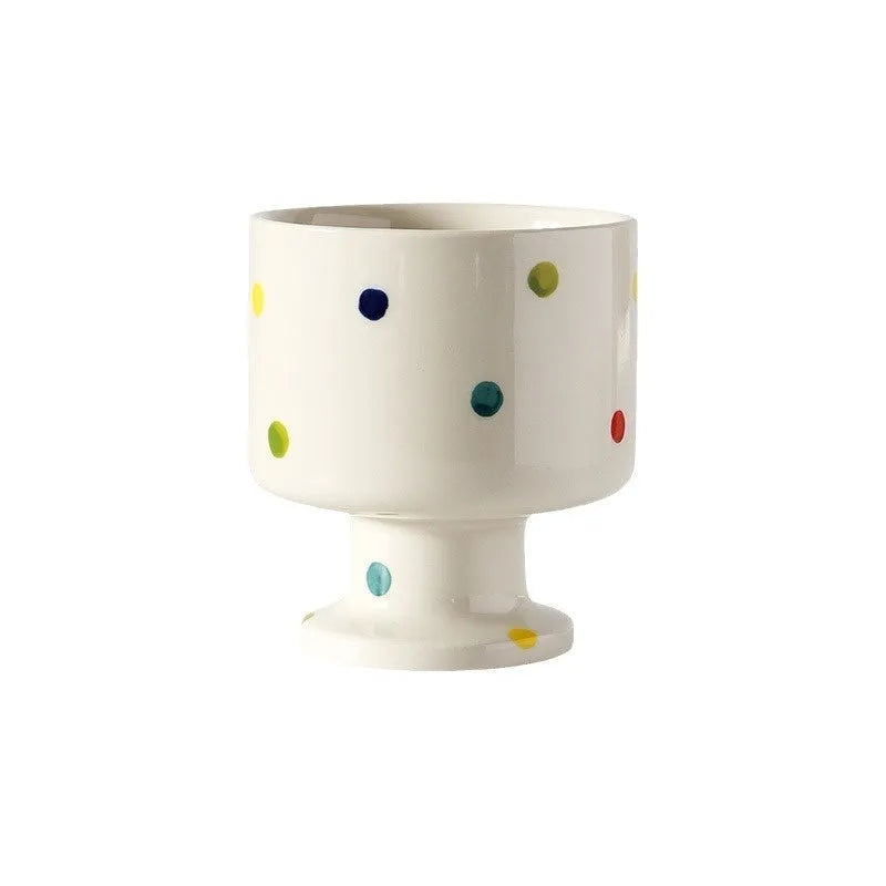 Hand-pinched irregular shaped ceramic mug in a solid colour, shown from the side.