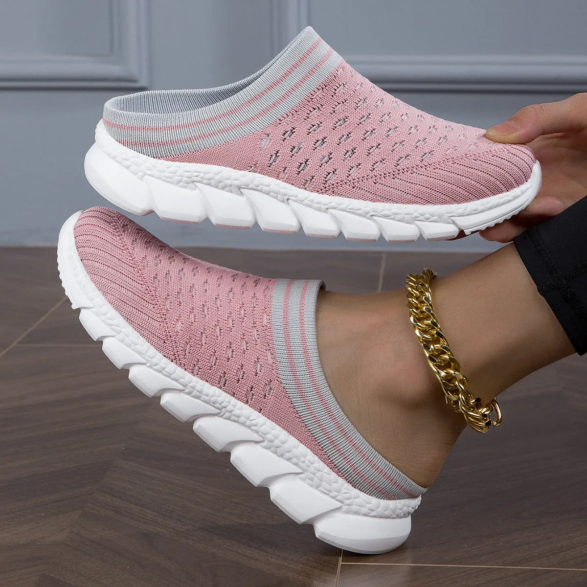 Women's black Flyknit slipper shoes with striped pattern and hollowed-out design on a viscose sole.