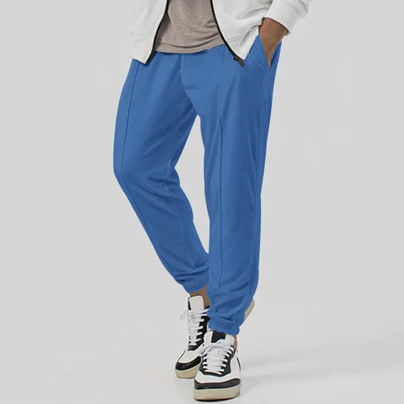 Men's grey casual track sweatpants with loose tapered cut and straight leg design, elastic waistband
