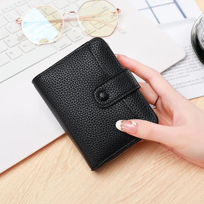 Ladies' short two-fold wallet in PU leather with a lychee pattern, shown in beige, pink, black, and red.