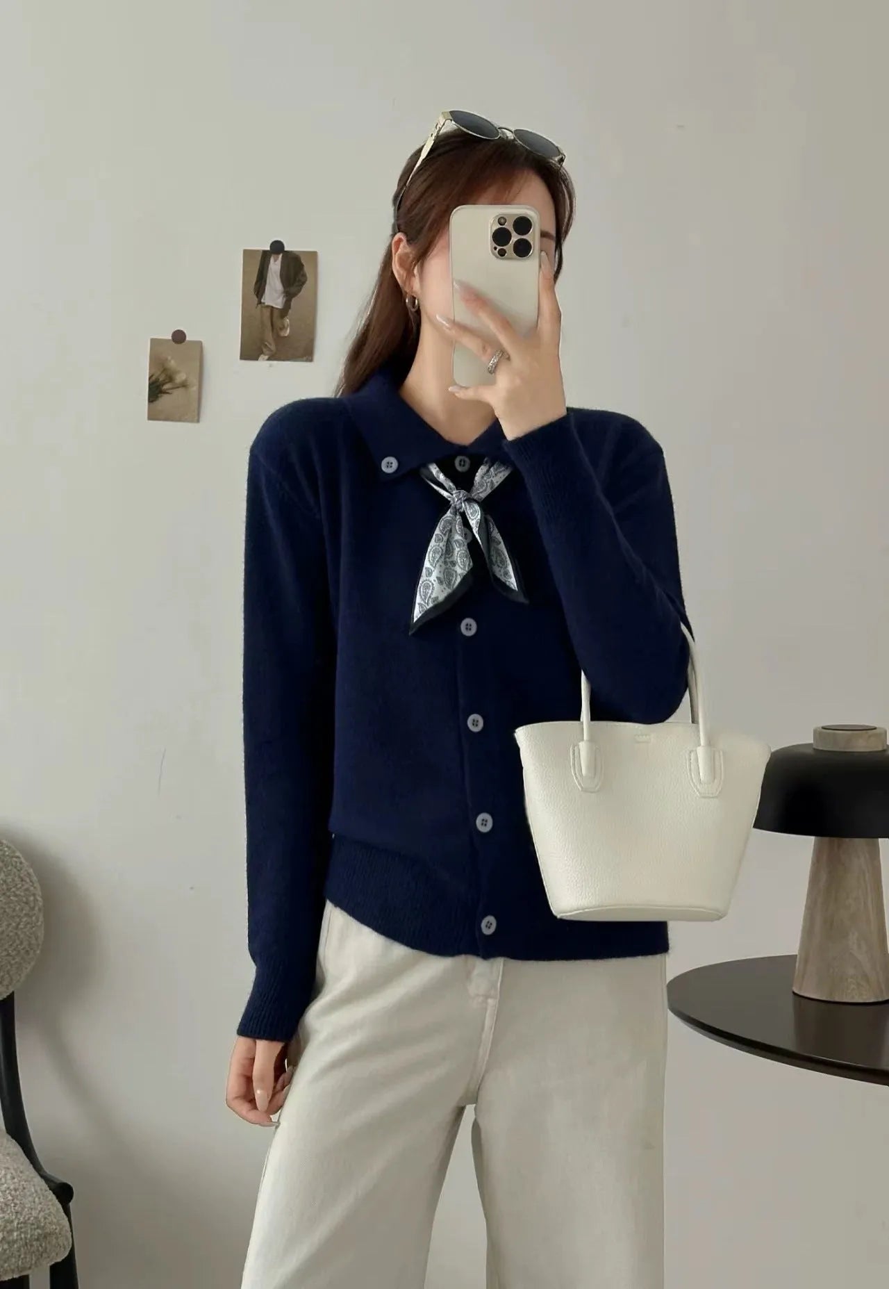 Beige cardigan sweater with a built-in lapel scarf and long sleeves laid flat
