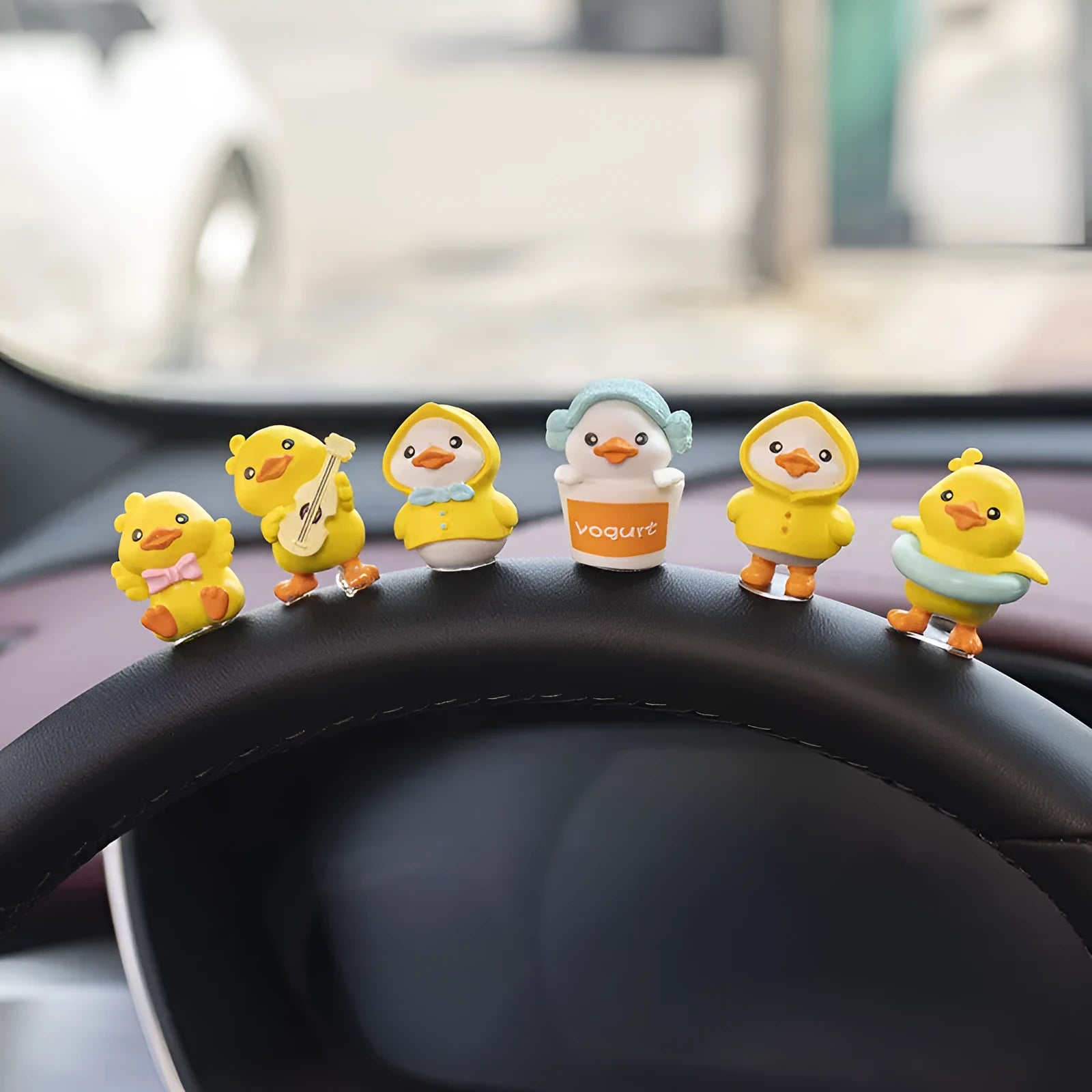 PVC cartoon duckling car decoration set with six small ducks and one Hello sign on a dashboard.