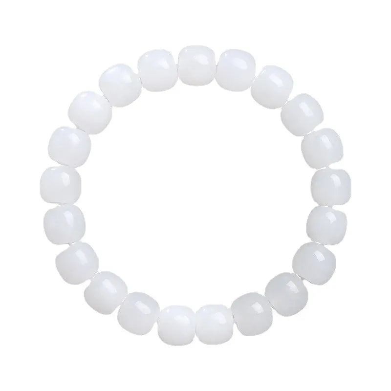 White Hetian jade barrel bead bracelet on a wrist, showing traditional unisex design.