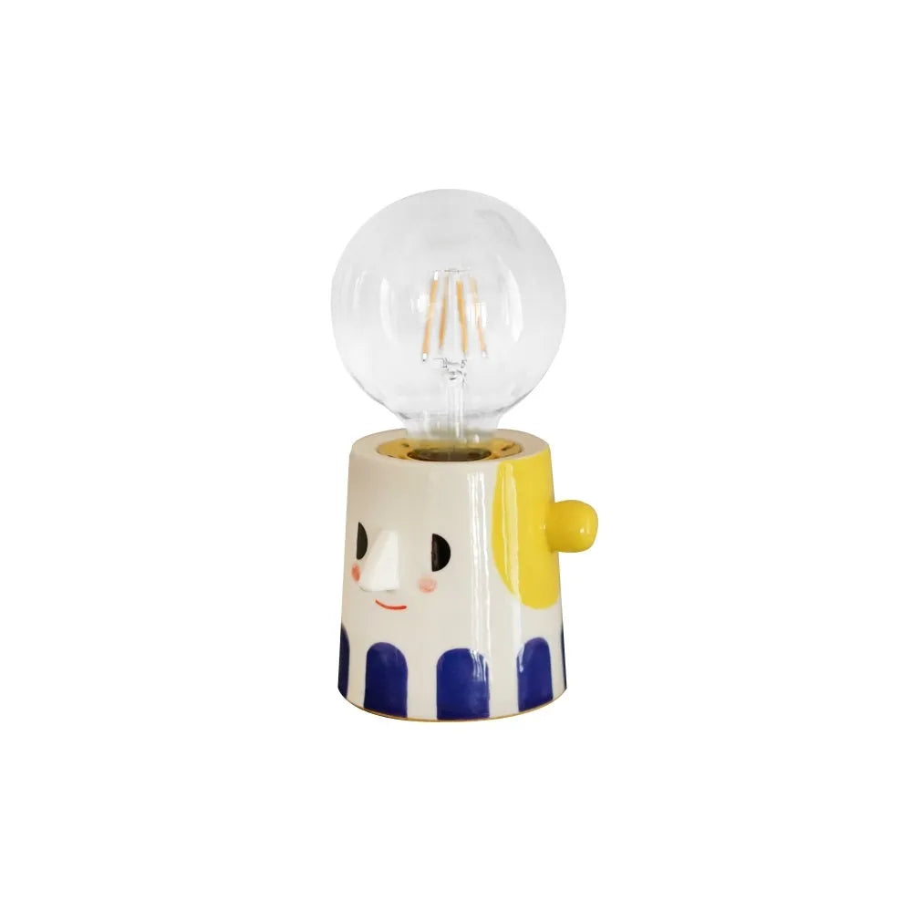 Handmade ceramic table lamp with a ball-shaped headlight on a neutral background.