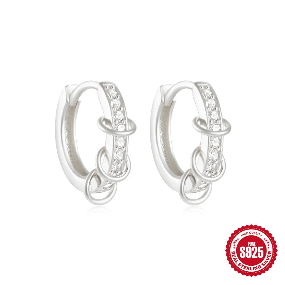 Sterling silver geometric stud earrings with a small round shape and classic diamond detail on a white background.