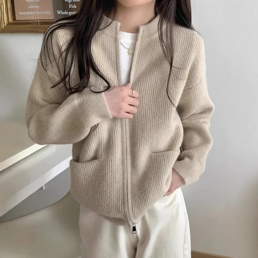 Beige viscose knit cardigan coat with long sleeves on a hanger.