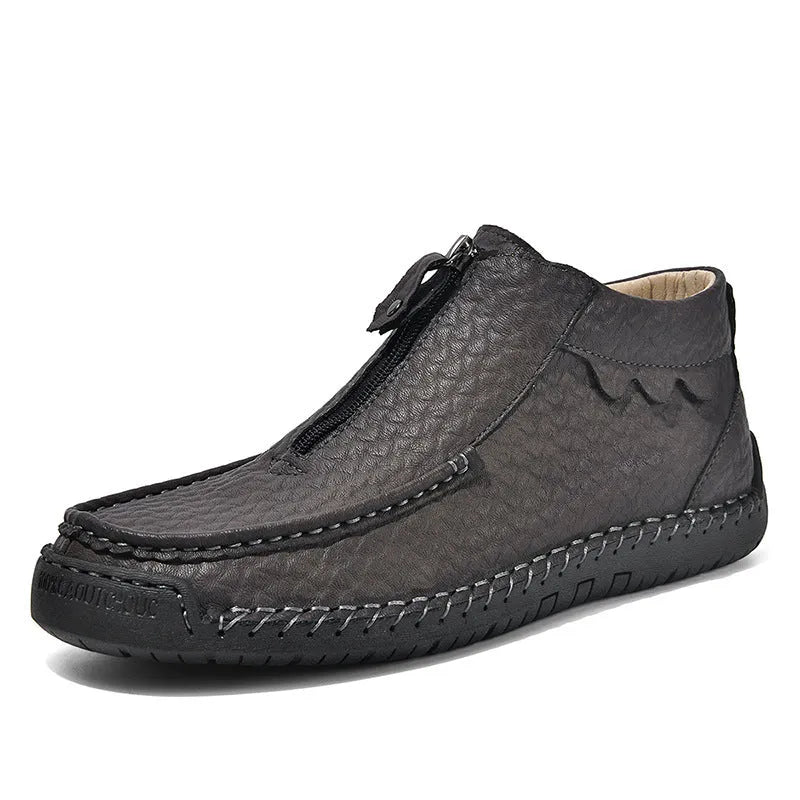 Men's black slip-on leather loafers with round toe and stitching detail on a solid colour background.