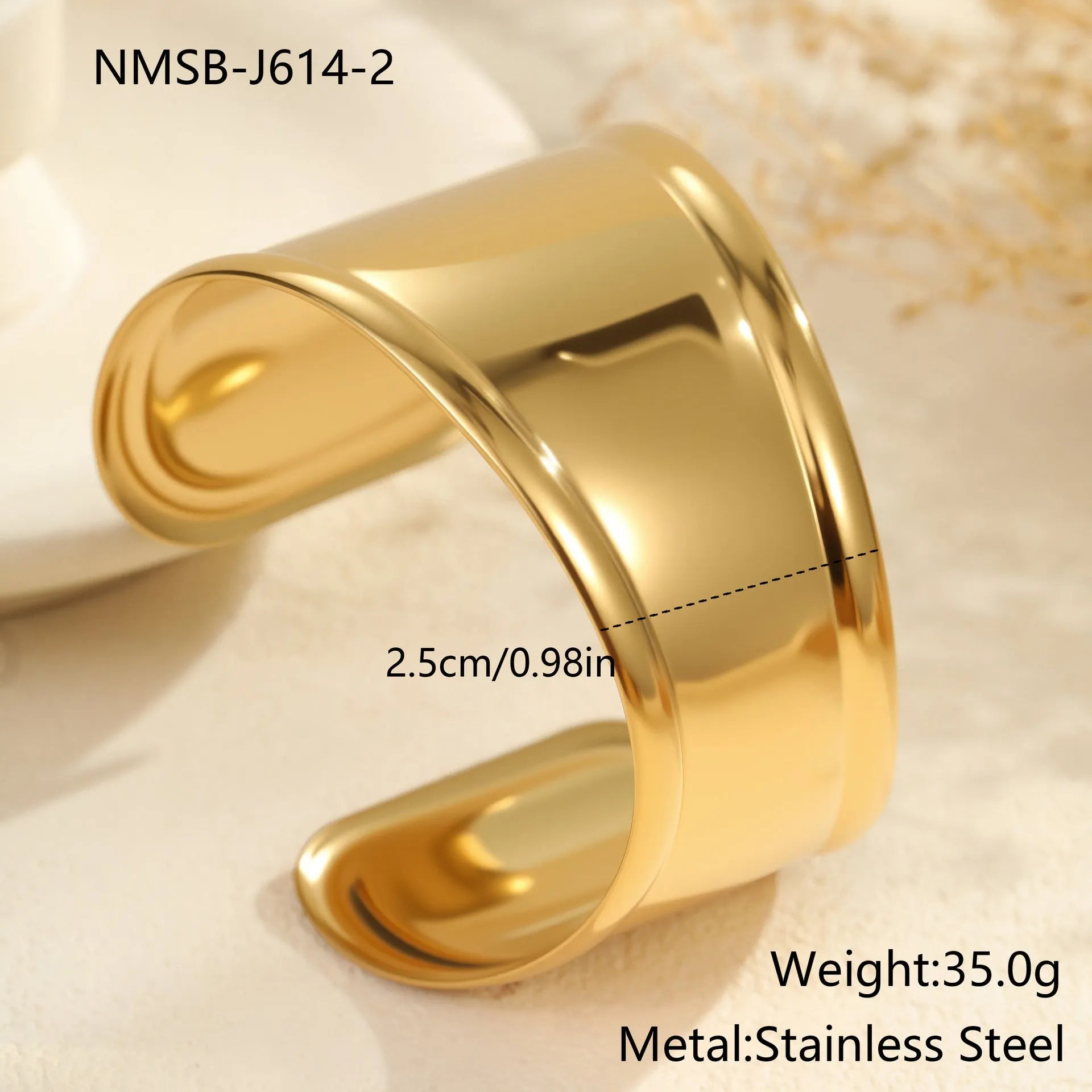 Women's wide stainless steel bracelet with 18K gold plating showing geometric wave patterns