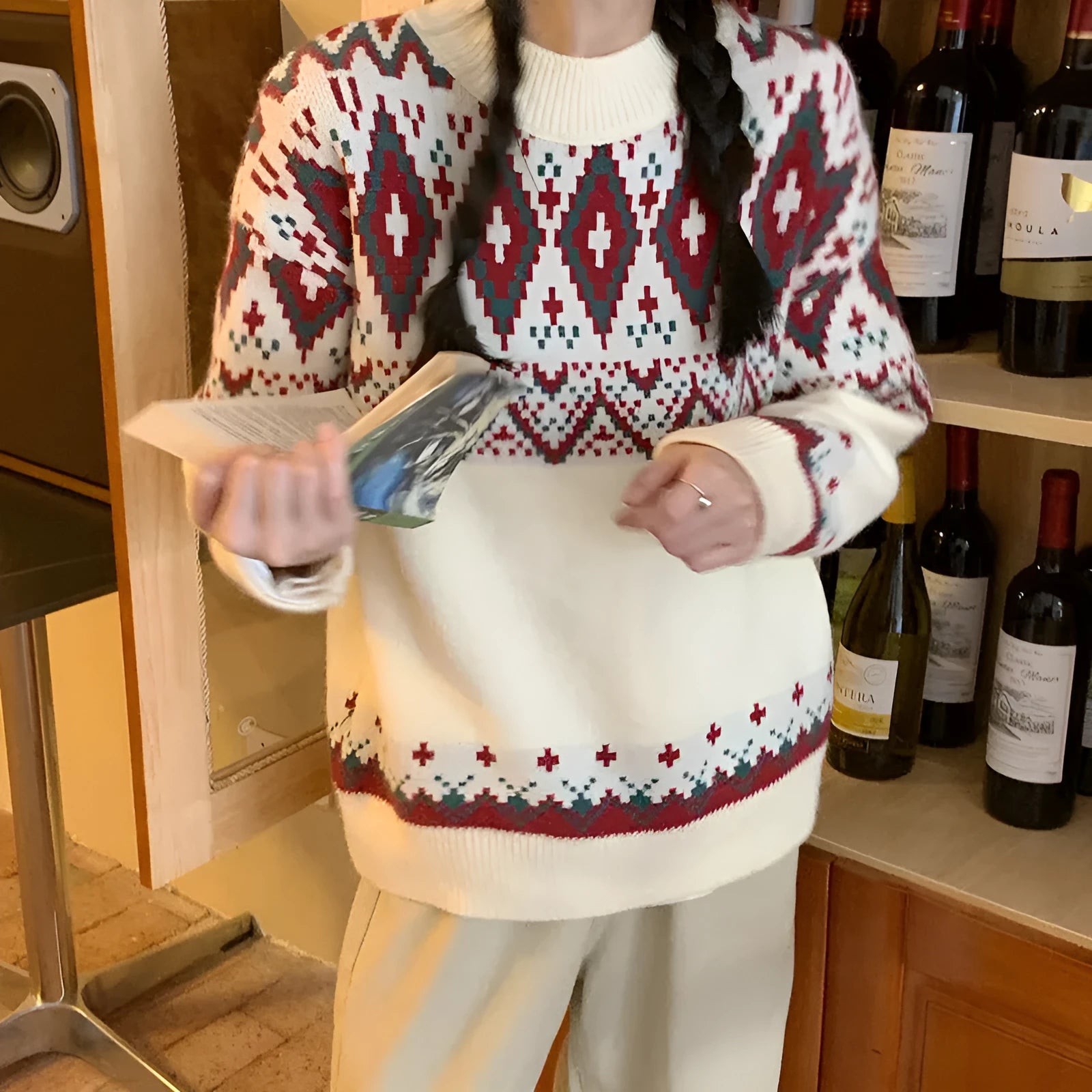 Red and white striped loose fit pullover knitted top with long sleeves on a mannequin.