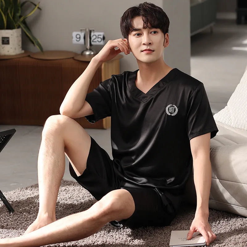 Man's ice silk short-sleeve pyjama shirt and shorts set in a loose, comfortable fit on a hanger