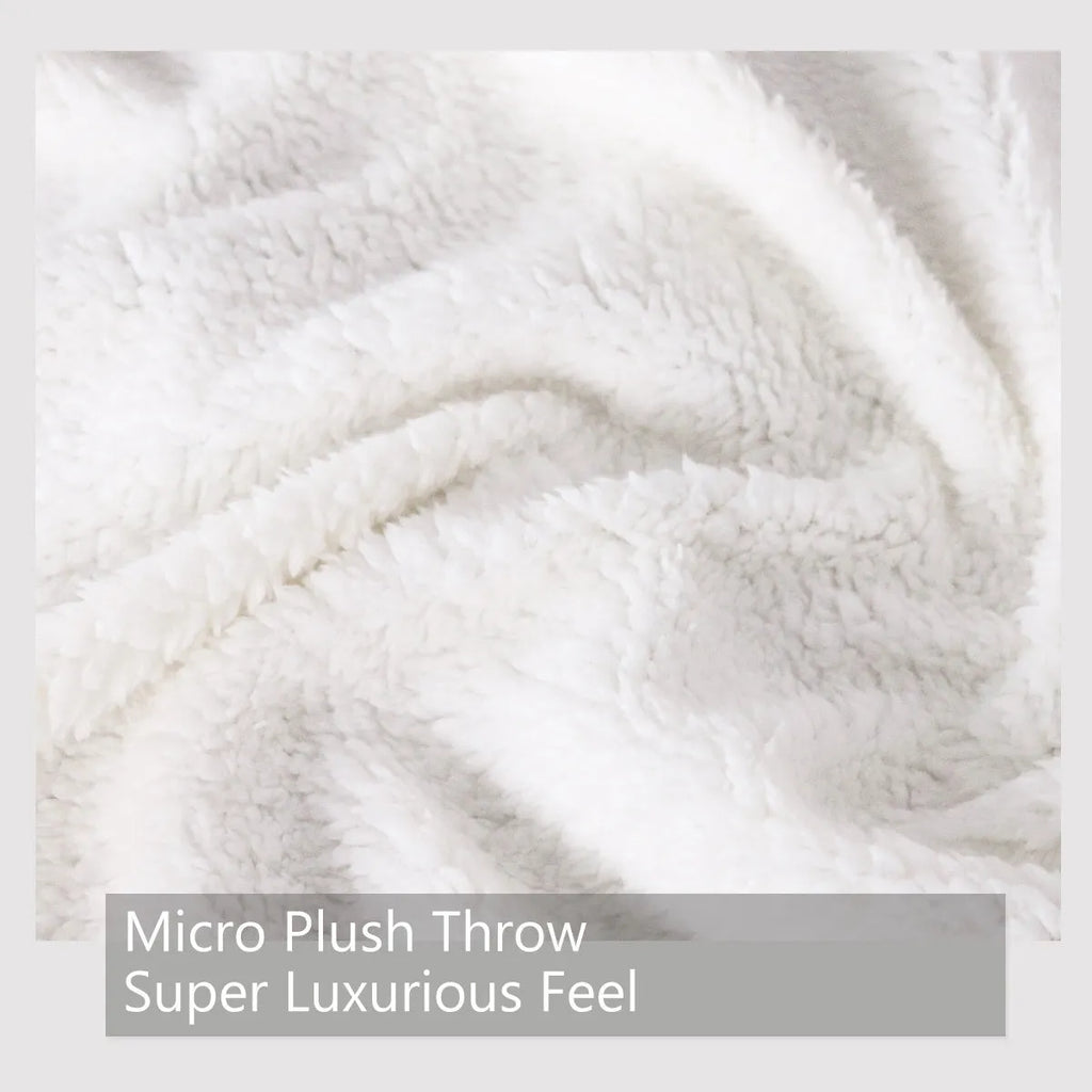 White Sherpa fleece blanket with tree leaf mushroom pattern, sized 130x150cm, on a sofa