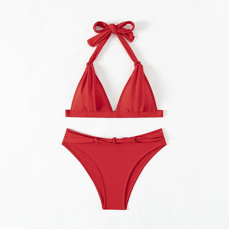 Red women's halterneck bikini set with lace-up front and matching split shorts.