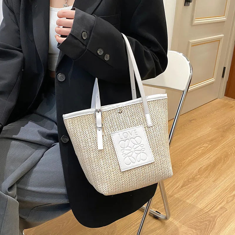 Straw woven women's shoulder bag in black with sewing thread detailing and large capacity design
