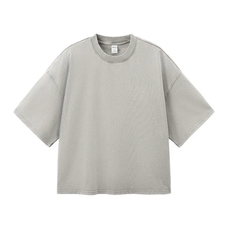 Men's loose vintage washed-out cotton t-shirt in khaki light colour, showing drop-shoulder sleeves and casual fit