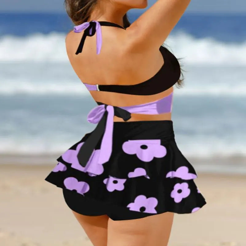 Women's purple bikini set with lace-up design featuring sleeveless top and high-waist split skirt