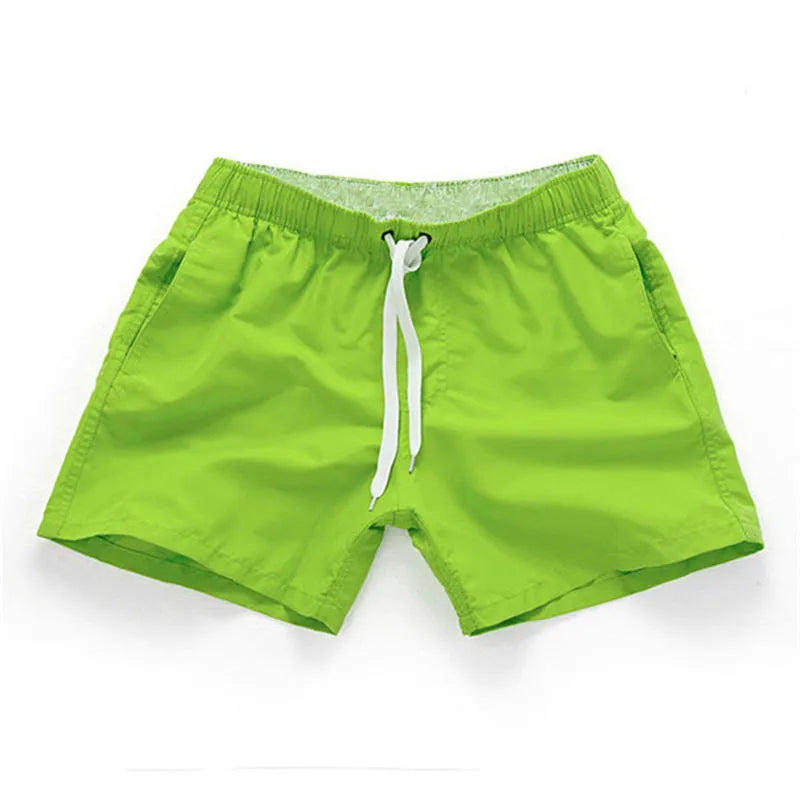 Men's polyester beach shorts with straight leg opening in multiple colours including black, white, and fluorescent yellow