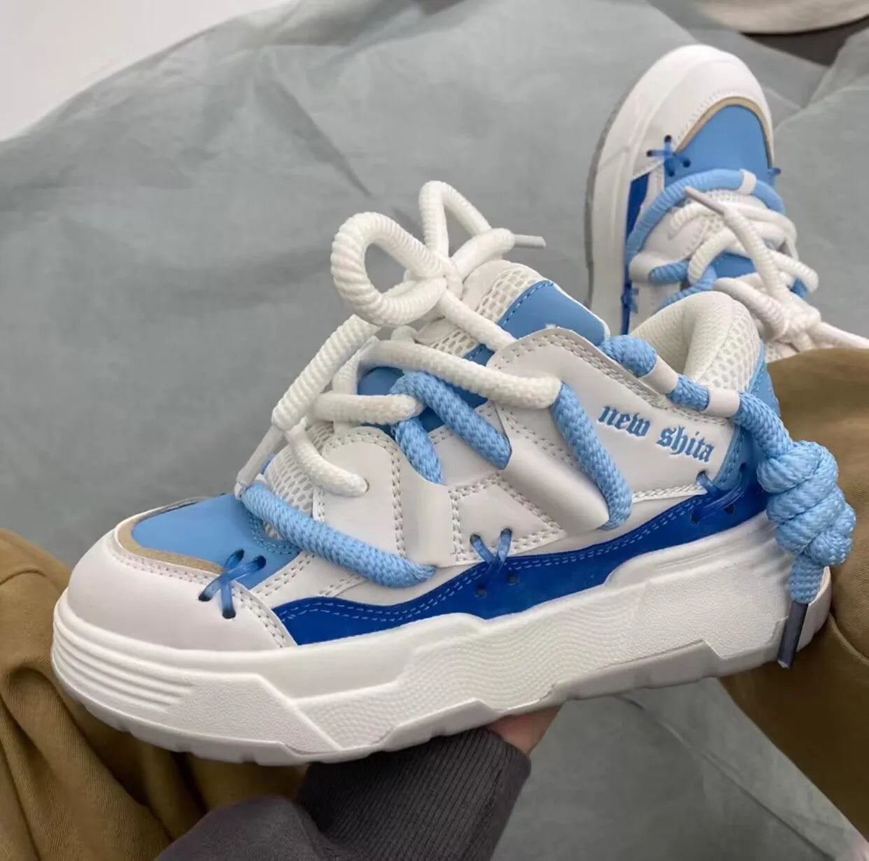 Women's grey retro chunky high-top sneakers with thick rubber platform sole and lace-up front.