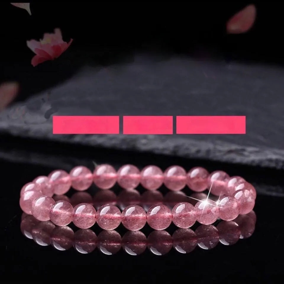 Women's strawberry quartz crystal bracelet with polished beads on an elasticated string.