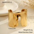 Women's wide stainless steel bracelet with 18K gold plating showing geometric wave patterns