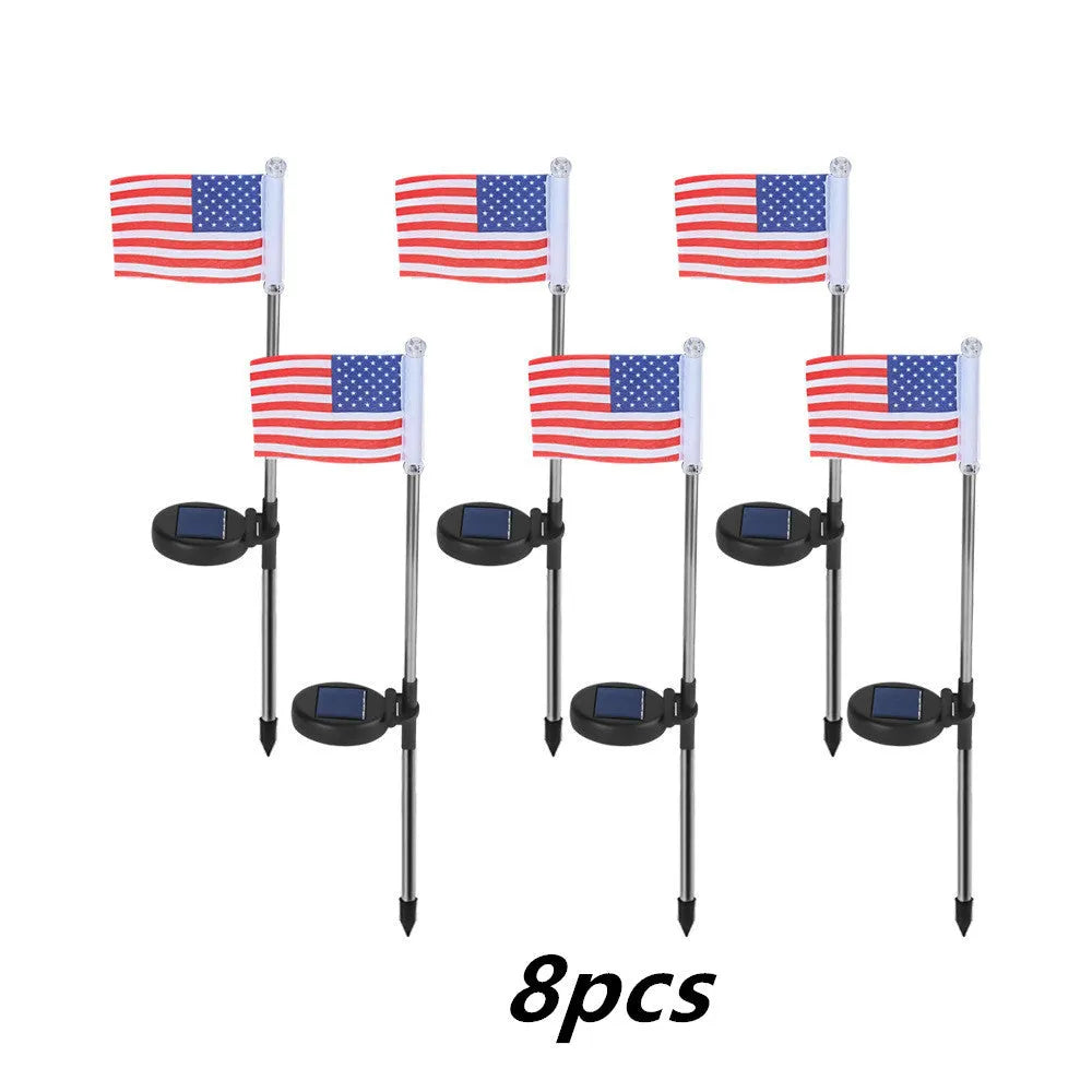 Solar garden flag light with stainless steel pole showing American flag design illuminated at night
