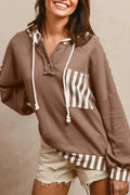 Straw yellow hoodie with waffle texture and striped patchwork design featuring drawstring hood and button neck closure