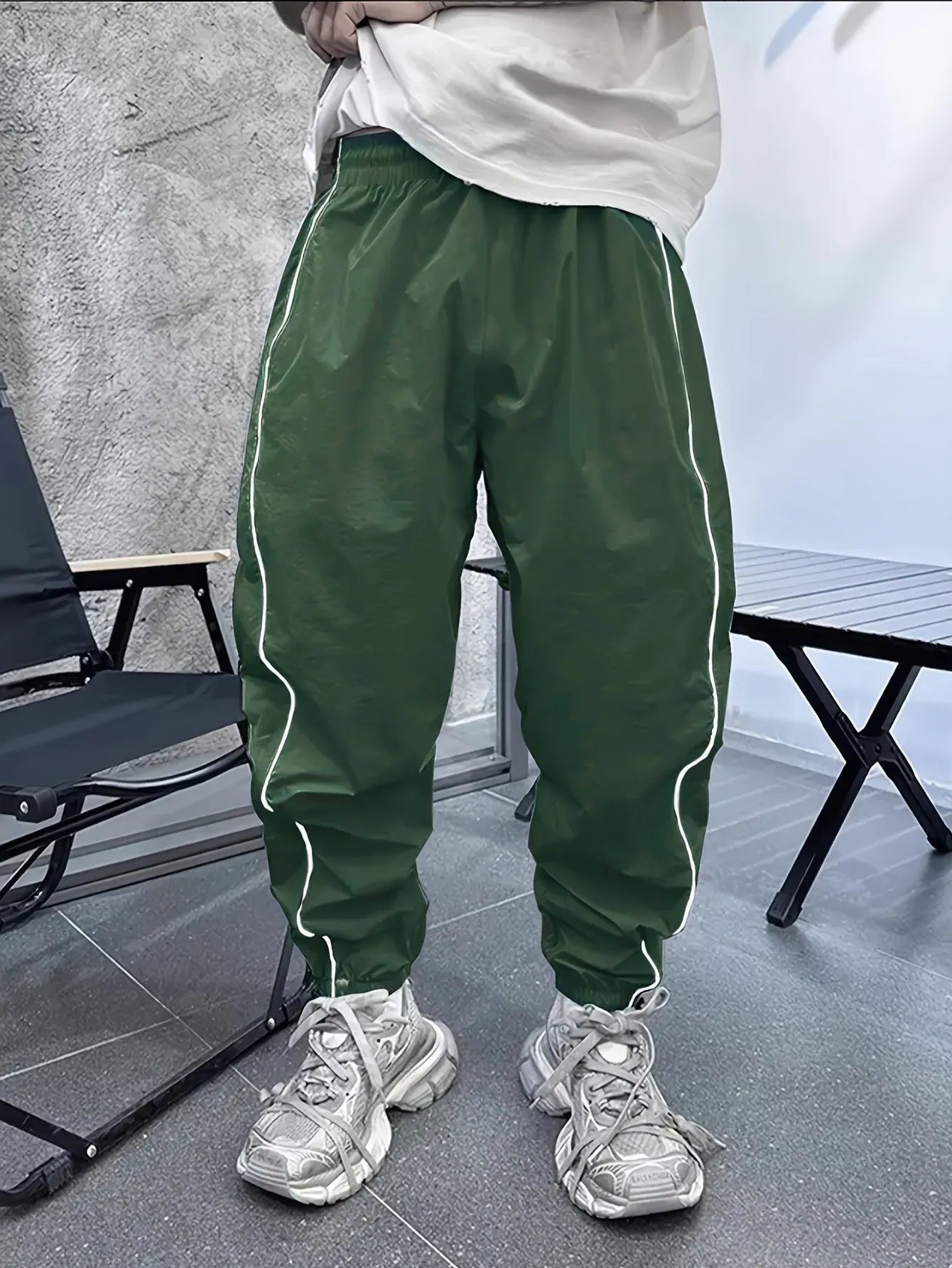 Men's blue bamboo fibre cropped sports trousers with a loose casual fit on a hanger.