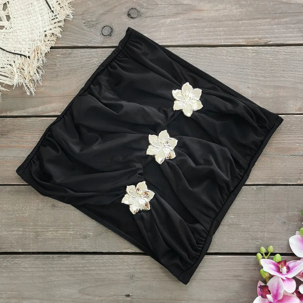 A solid colour one-piece swimsuit for women with a hollow-out tube top and a matching short skirt.