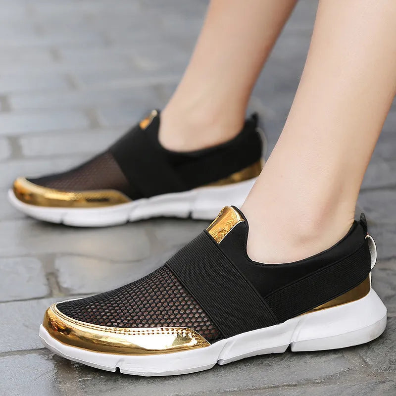 Blue, black, and grey women's low-cut mesh sneakers with a PU midsole on a hard floor.