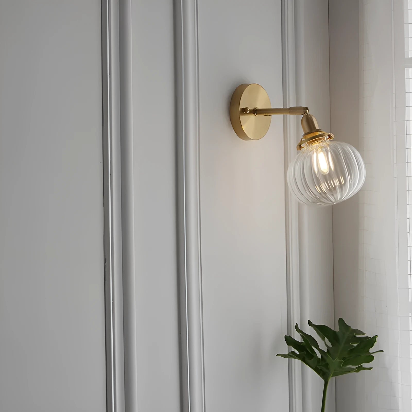 Pumpkin-shaped glass wall lamp in a choice of blue, clear, or water ripple transparent finish.