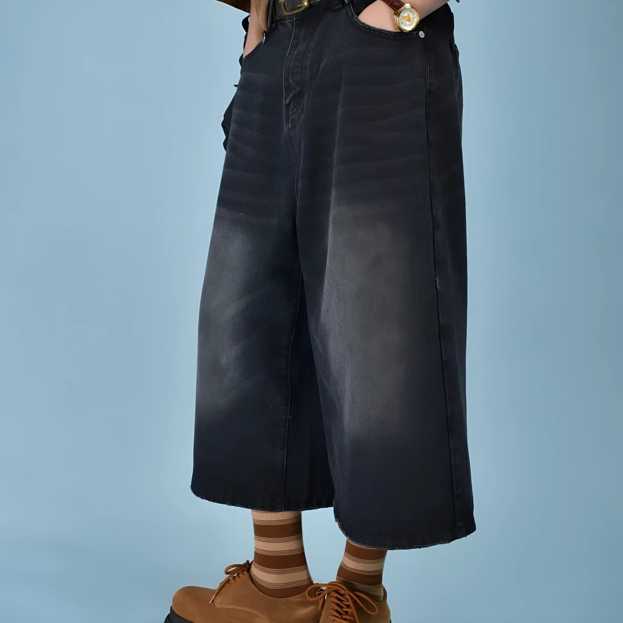Man wearing blue loose straight-leg denim shorts for summer.