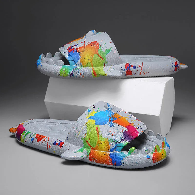 Cute shark design open toe EVA home slippers in assorted colours on a white background.