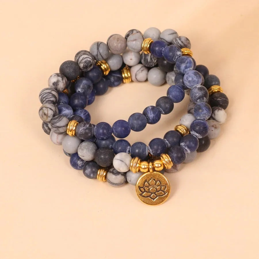 Blue patterned network stone beads on a multi layer alloy chain bracelet
