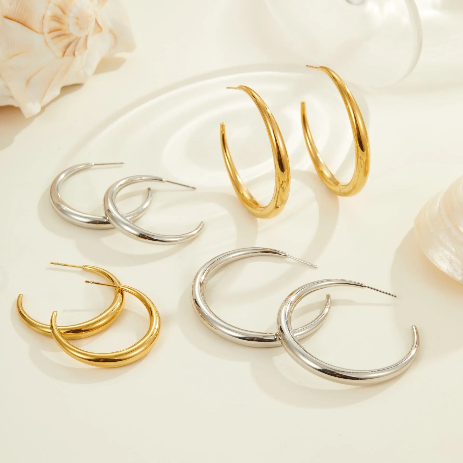 Titanium steel hoop earrings with geometric round shape in gold and steel colour options