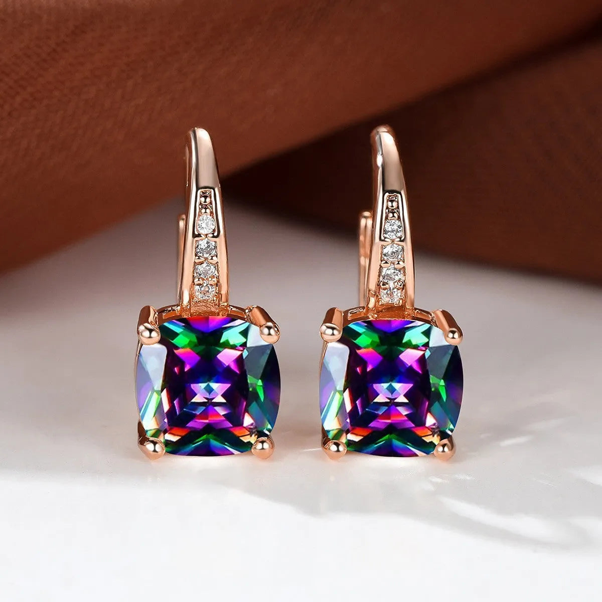 Square geometric ear hook earrings with zircon stones in an electroplated copper setting.