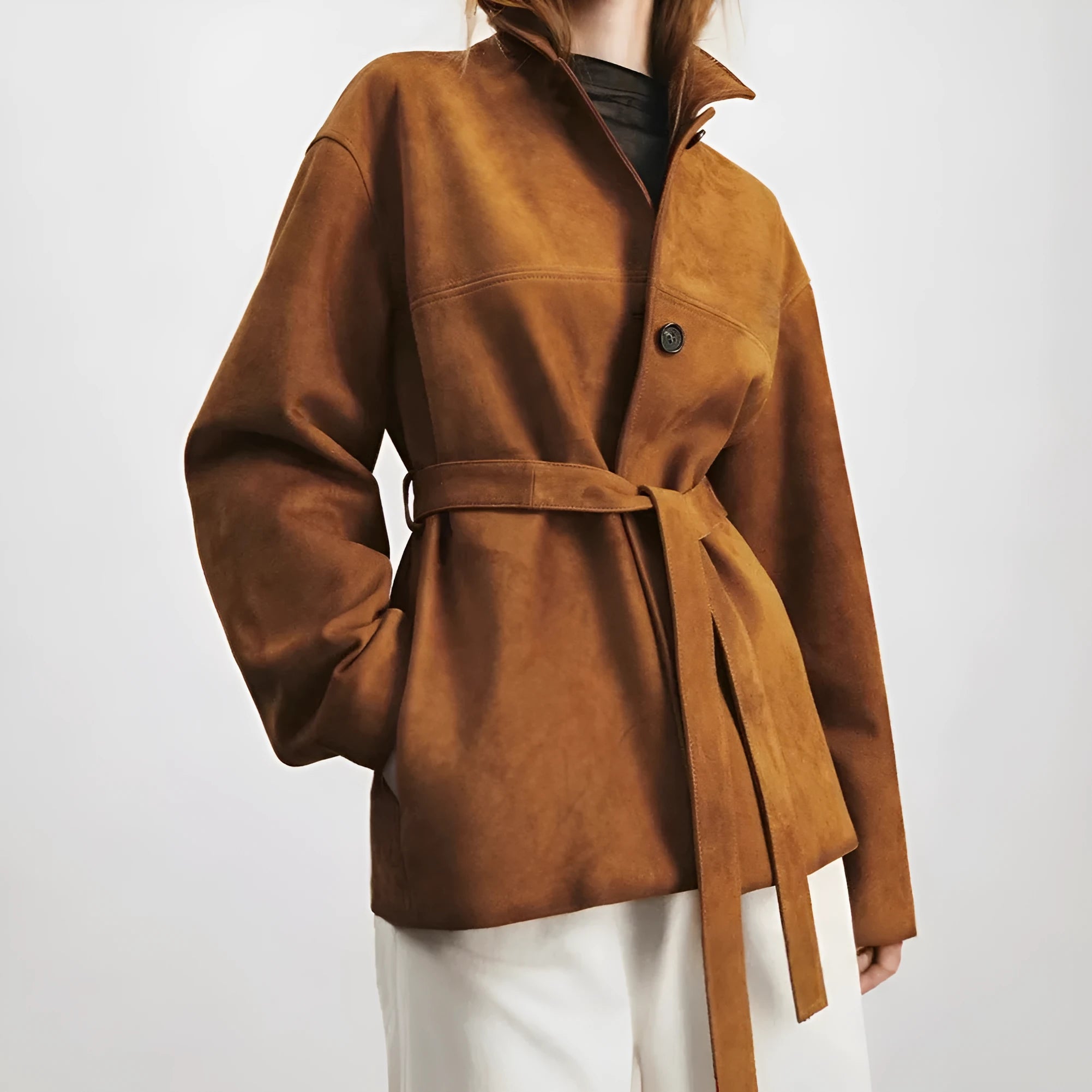 Women's mid-length caramel mocha cashmere coat with Peter Pan collar and leather stitching detail.