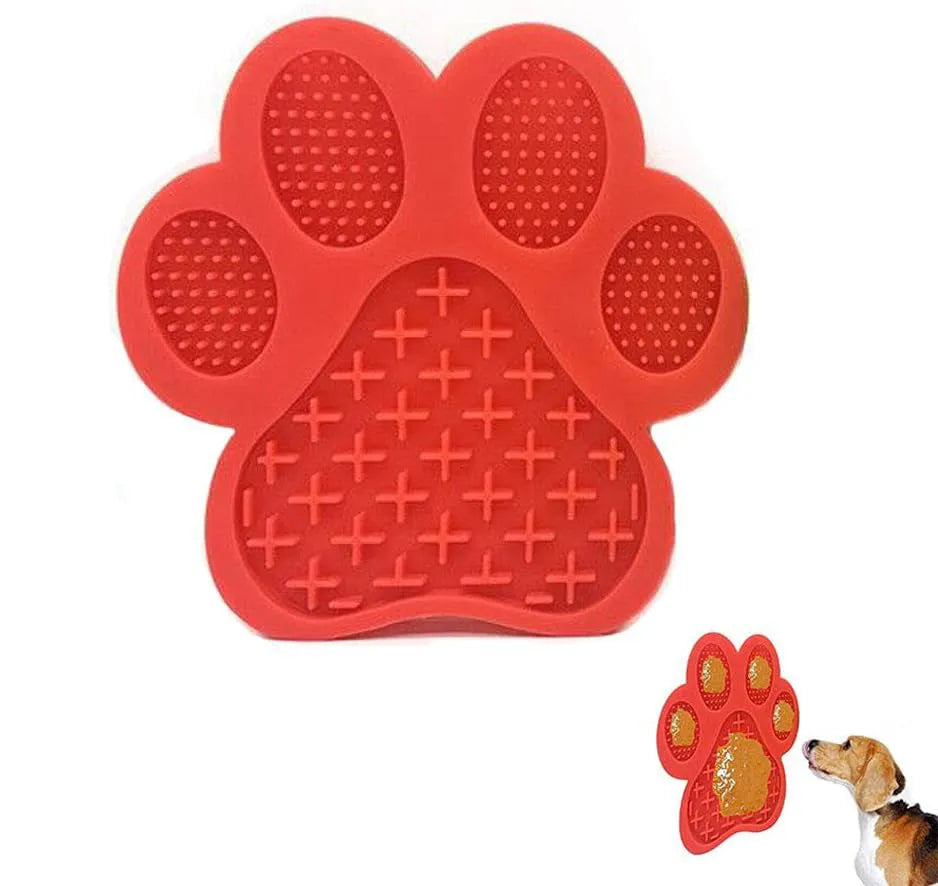 Blue silicone dog licking mat with bone texture and suction cups on a white bathroom tile.