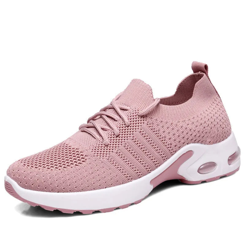 Women's black mesh casual sneakers with round toe and white lace-up front on a grey PVC sole.