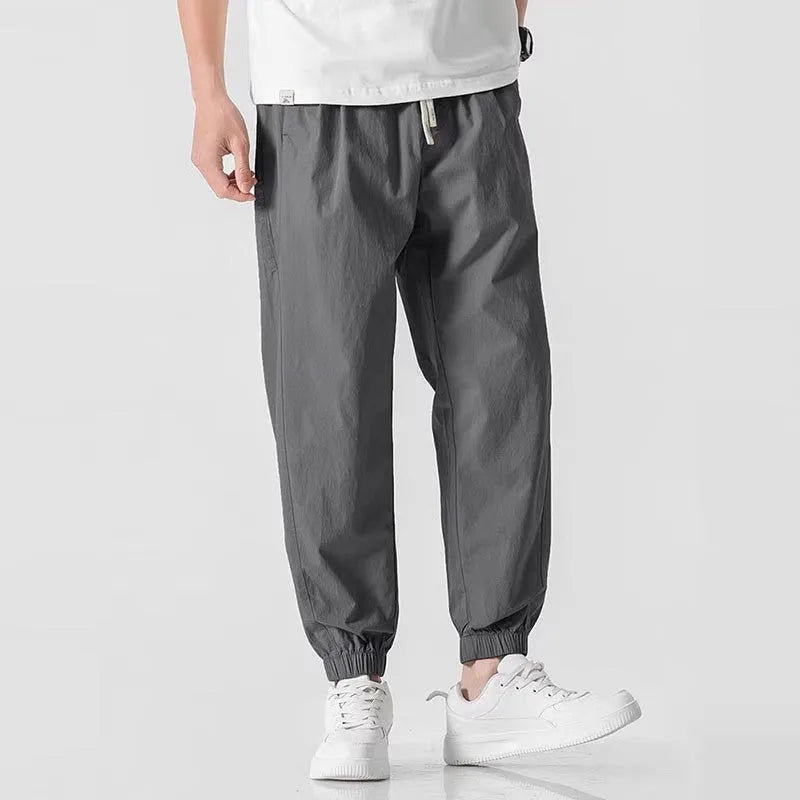 Men's fashion loose cuffed cargo pants in black, made from polyester, available in sizes S to 3XL.