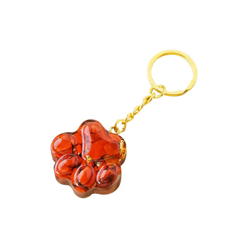 Natural crystal cat's paw keychain pendant in various gemstone colours including pink, red, blue, and green